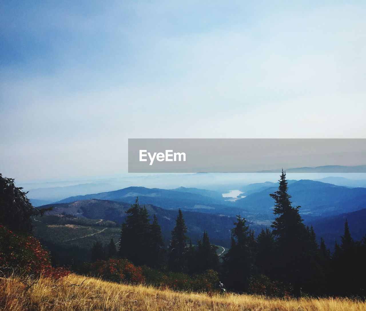 SCENIC VIEW OF LANDSCAPE AND MOUNTAINS AGAINST SKY