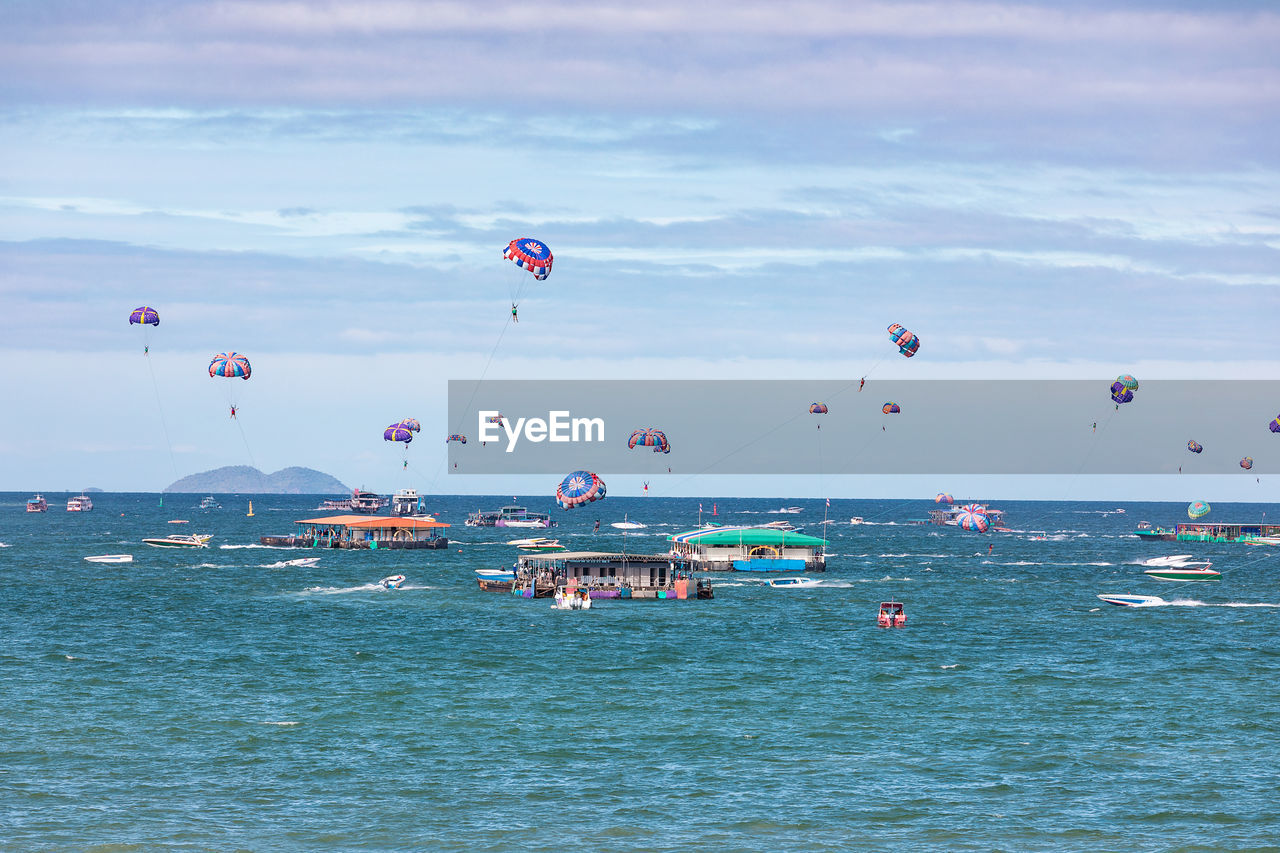 People parasailing at pattaya beach thailand