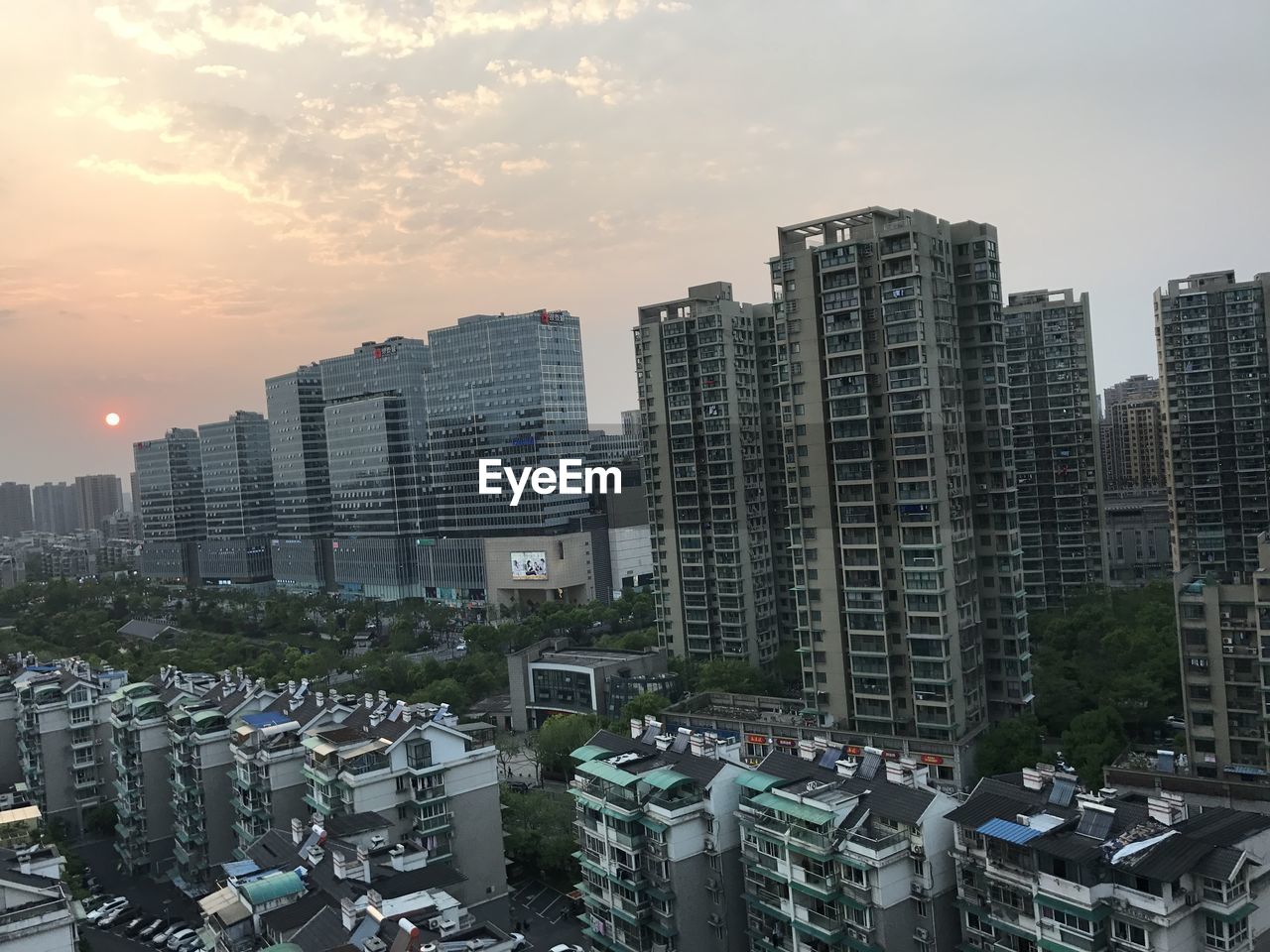 Aerial view of cityscape against sky during sunset