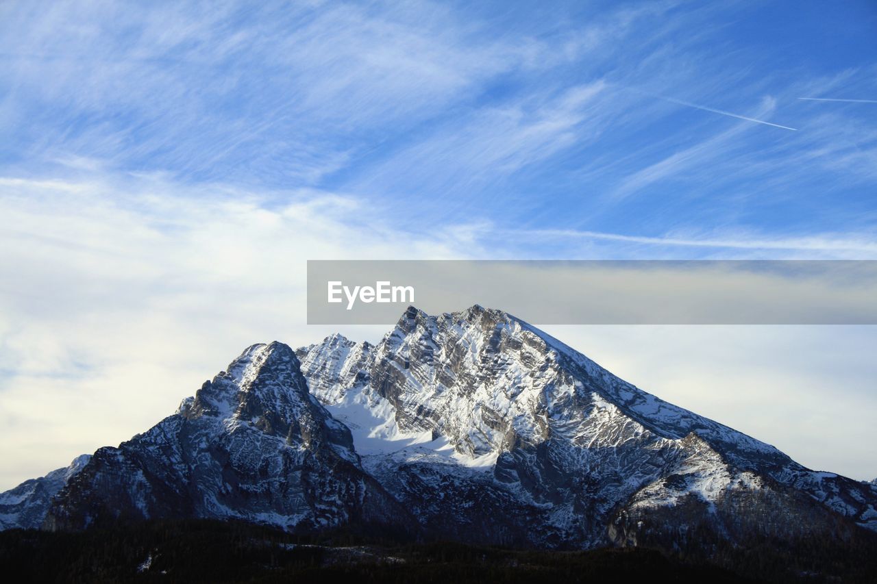 Low angle view of snowcapped mountains against sky