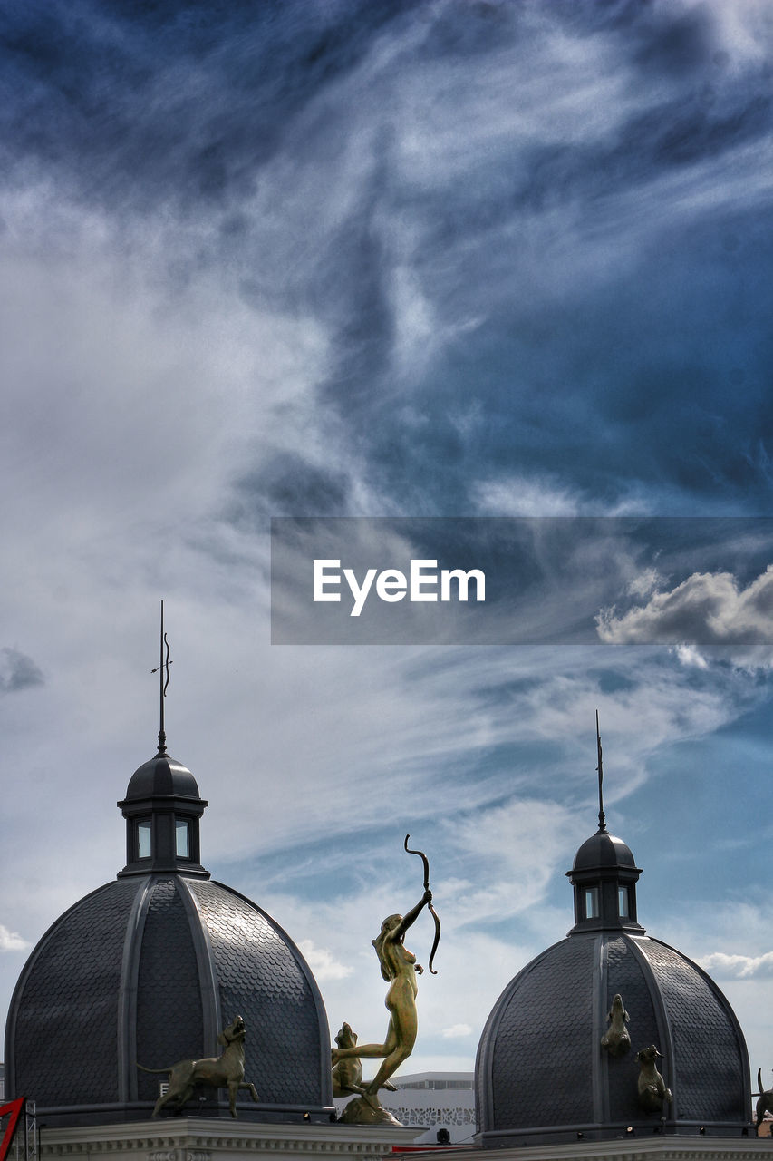 Statue and dome against sky