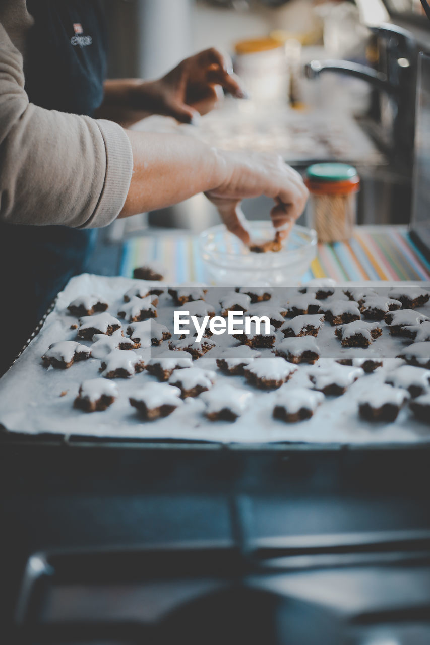 Midsection of woman preparing cookies