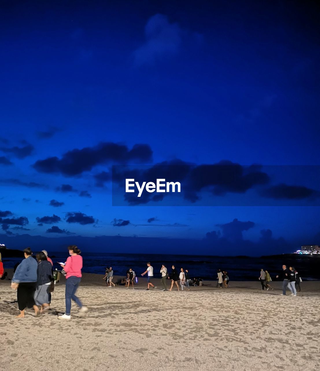 PEOPLE ON BEACH AGAINST SKY