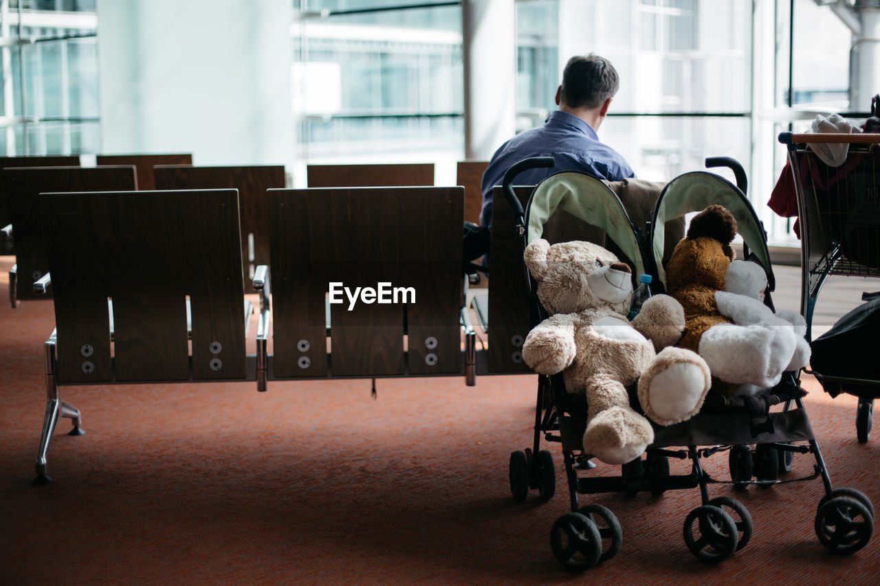 Teddy bears in baby stroller at airport