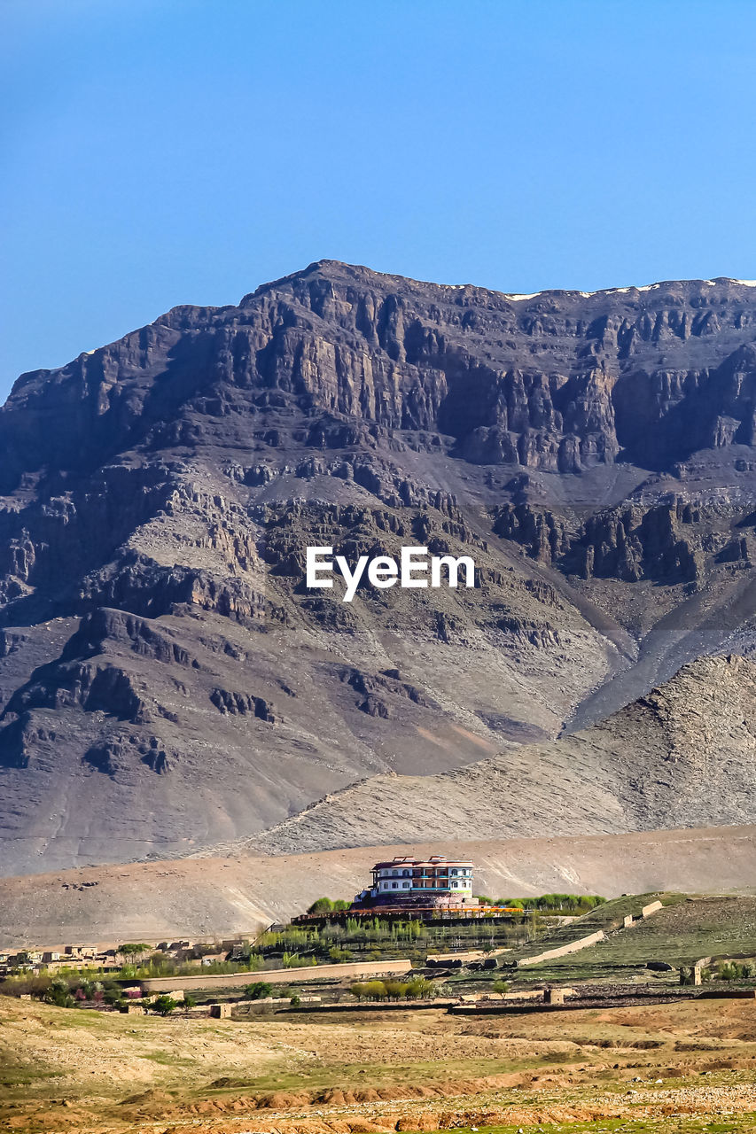 A large house and a mountain in the background. a large house near kabul, afghanistan. detached. 
