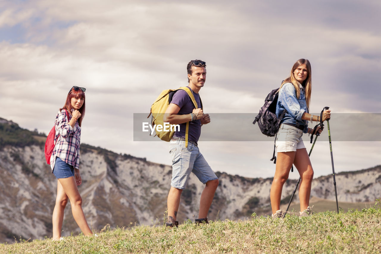 Group of young hikers in the mountain in single file