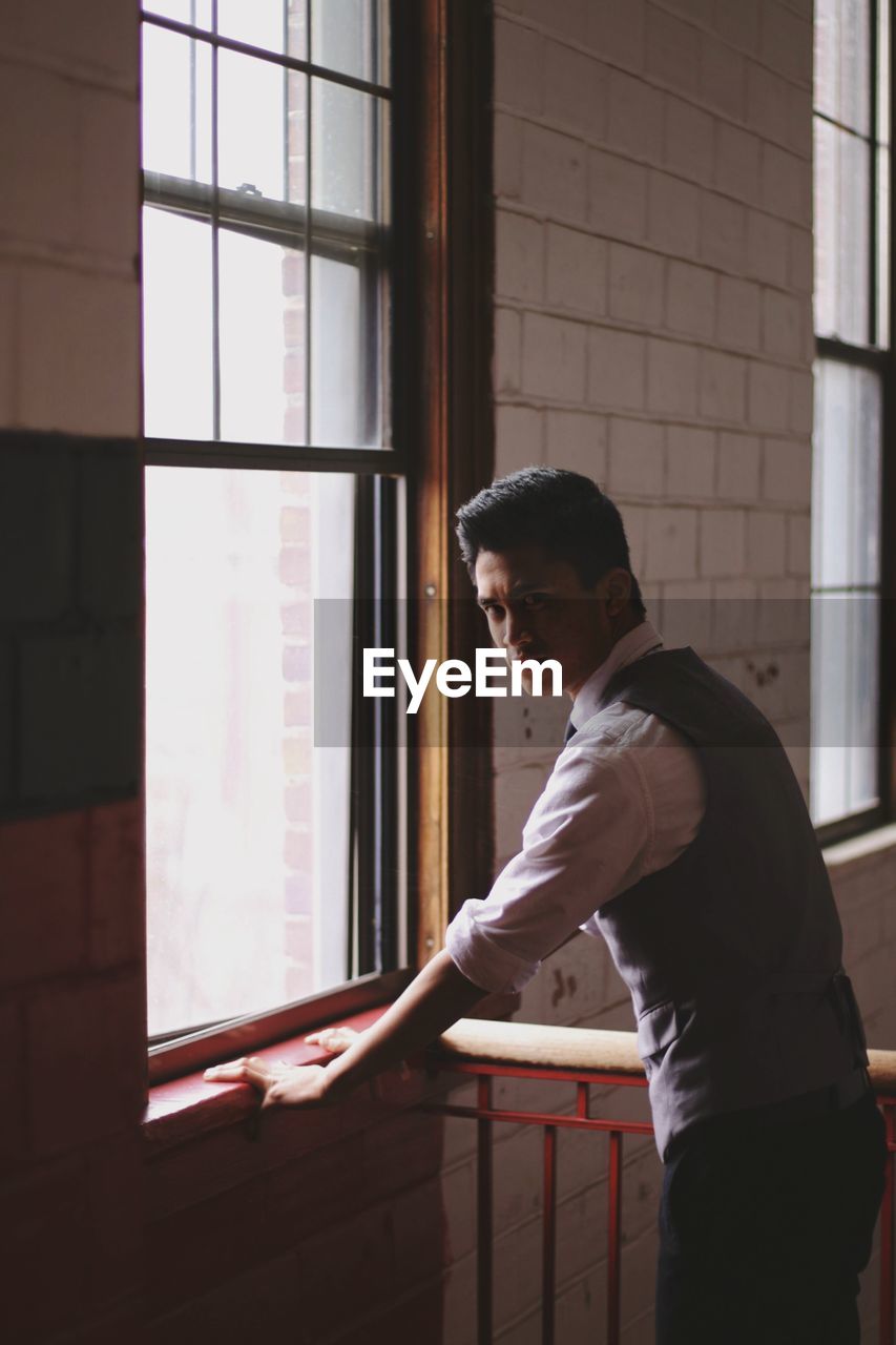 Man standing at window