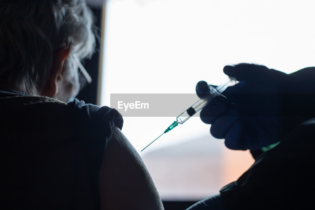 healthcare and medicine, adult, blue, indoors, person, men, two people, occupation, conversation, holding, rear view, women, headshot, black, medicine, doctor, activity, portrait, human face, expertise