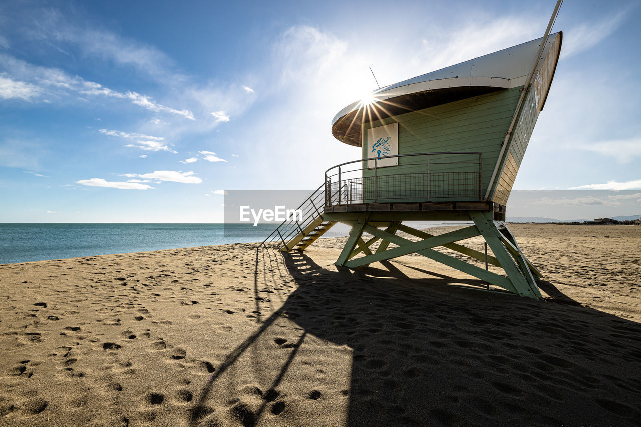 Built structure on beach against sky