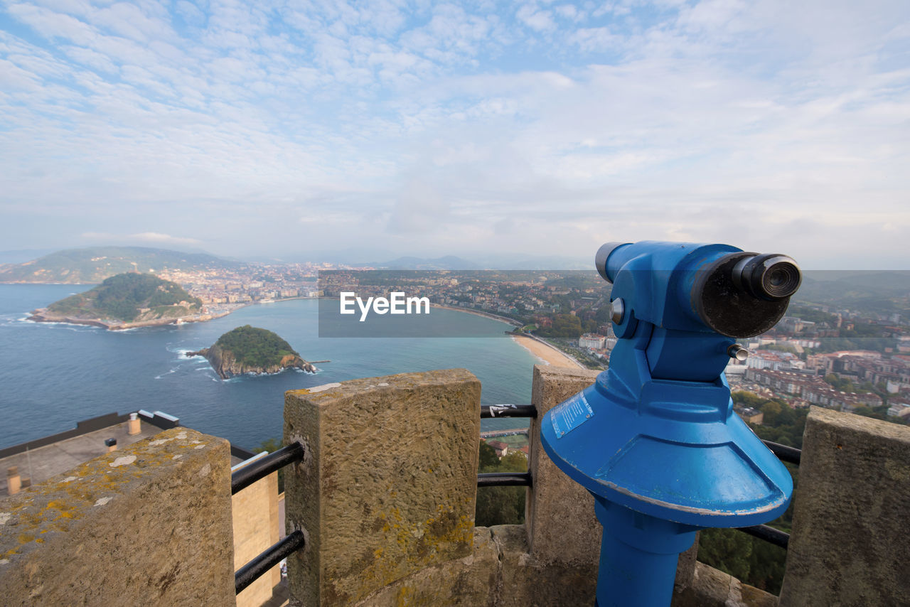 SEA AND CITYSCAPE AGAINST SKY