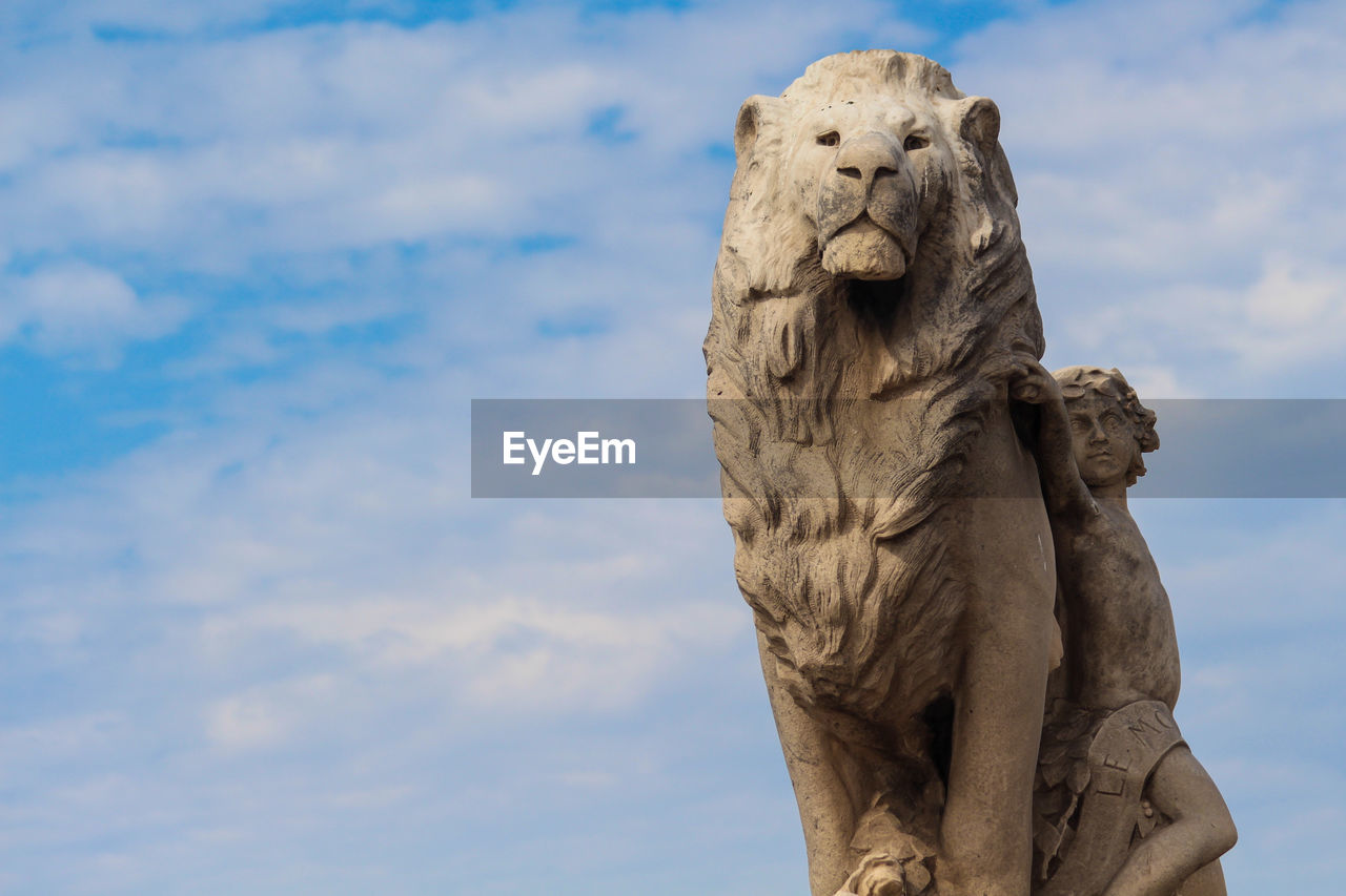 sculpture, statue, sky, cloud, monument, representation, animal, no people, craft, nature, lion - feline, animal themes, day, temple, art, creativity, animal representation, animal wildlife, mammal, low angle view, architecture, outdoors, carnivore, human representation, rock, sand, feline, one animal