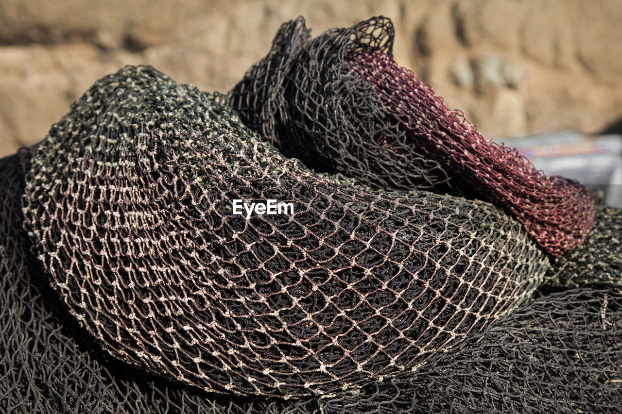 Close-up of fishing nets on sunny day