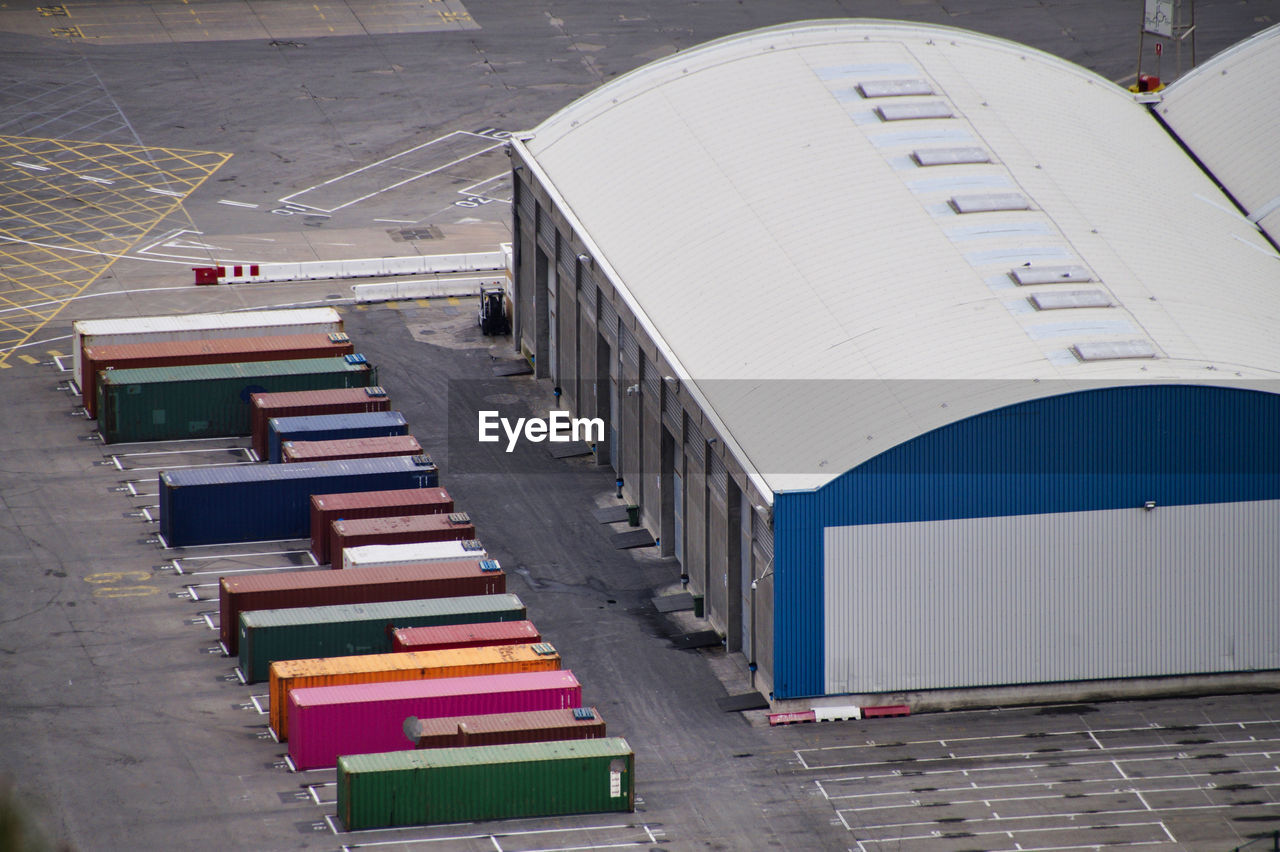 High angle view of multi colored cargo container at commercial dock 