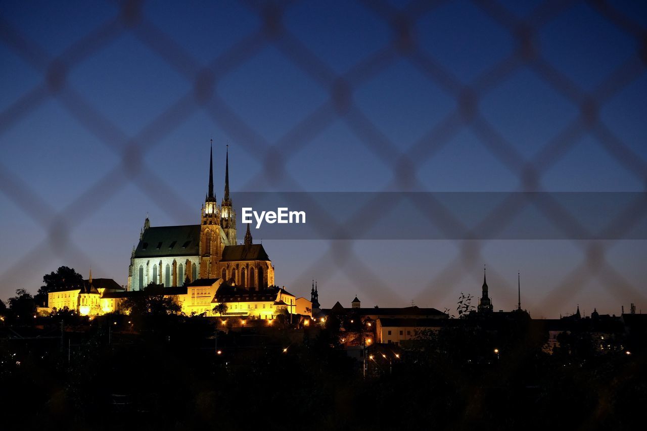 Illuminated buildings in city at dusk