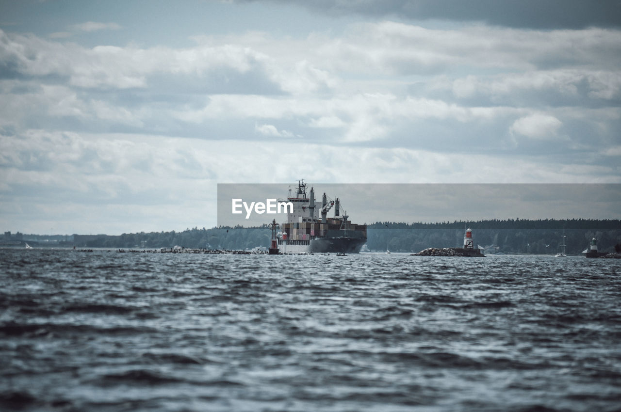 Ship sailing on sea against sky