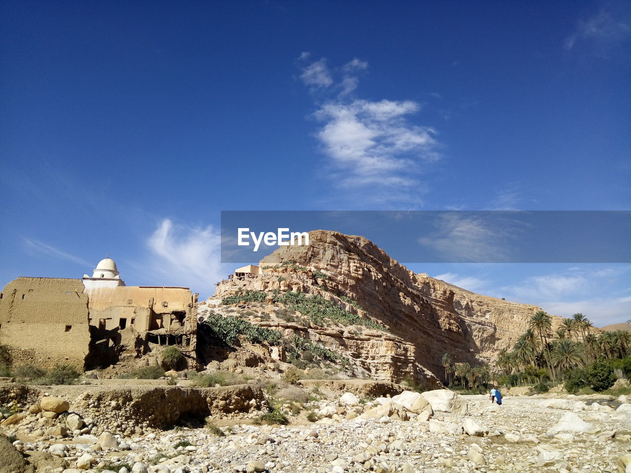 Panoramic view of rocks and mountains against blue sky