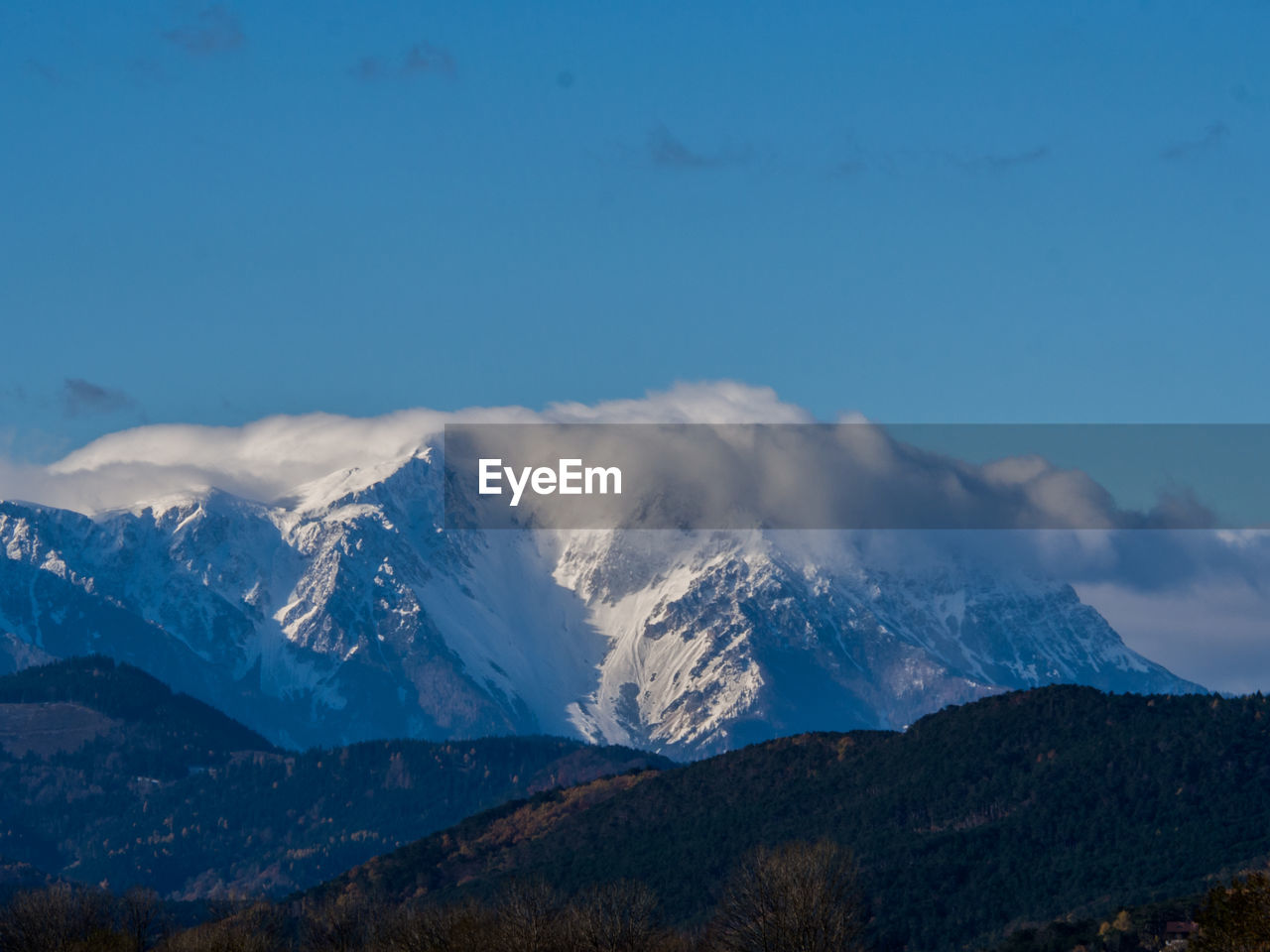 Scenic view of snowcapped mountains against sky