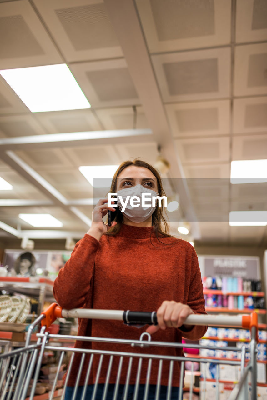 Woman wearing mask shopping at mall