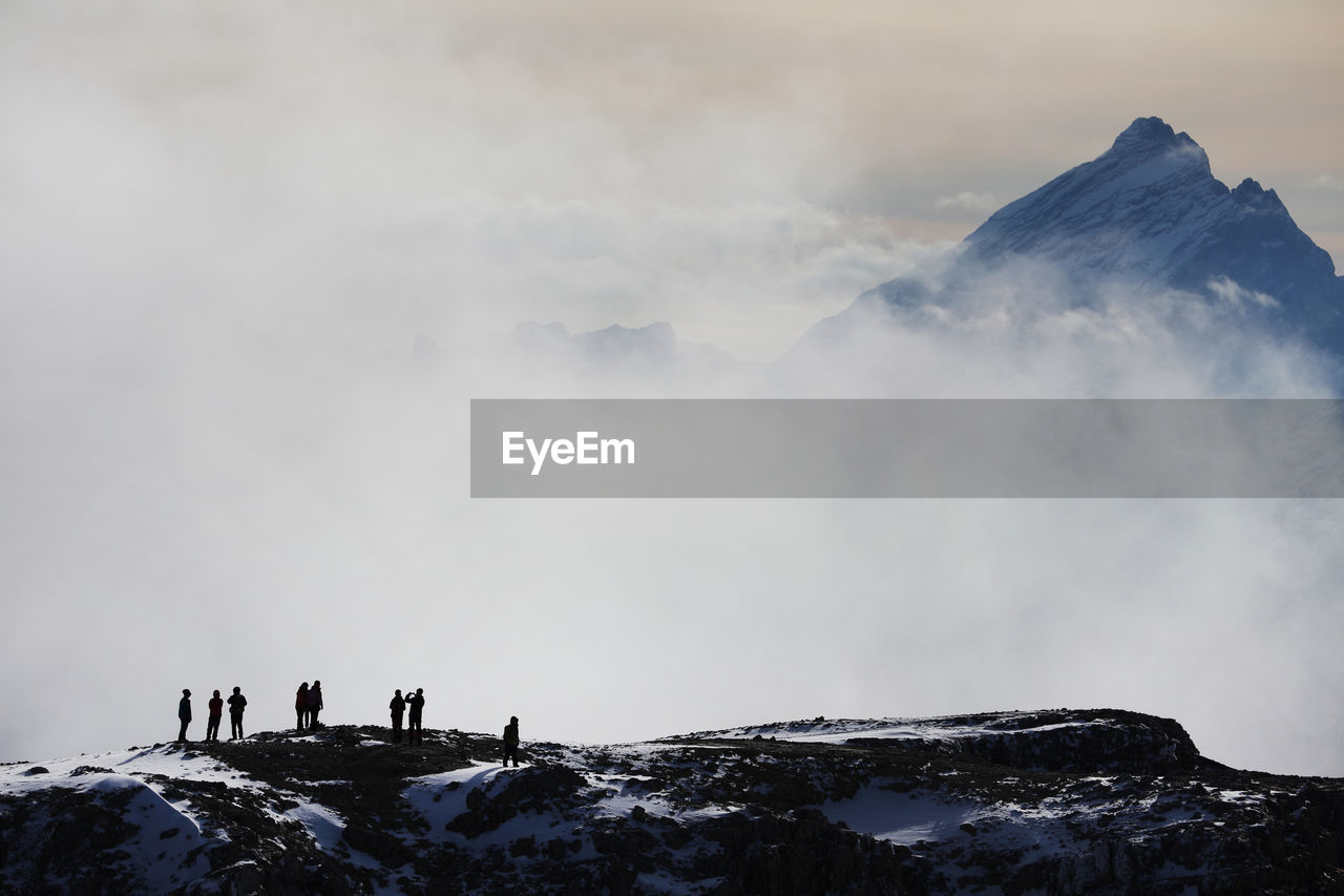 Scenic view of rocky mountains  in fog