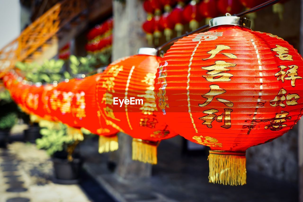 RED LANTERNS HANGING ON STREET LIGHT