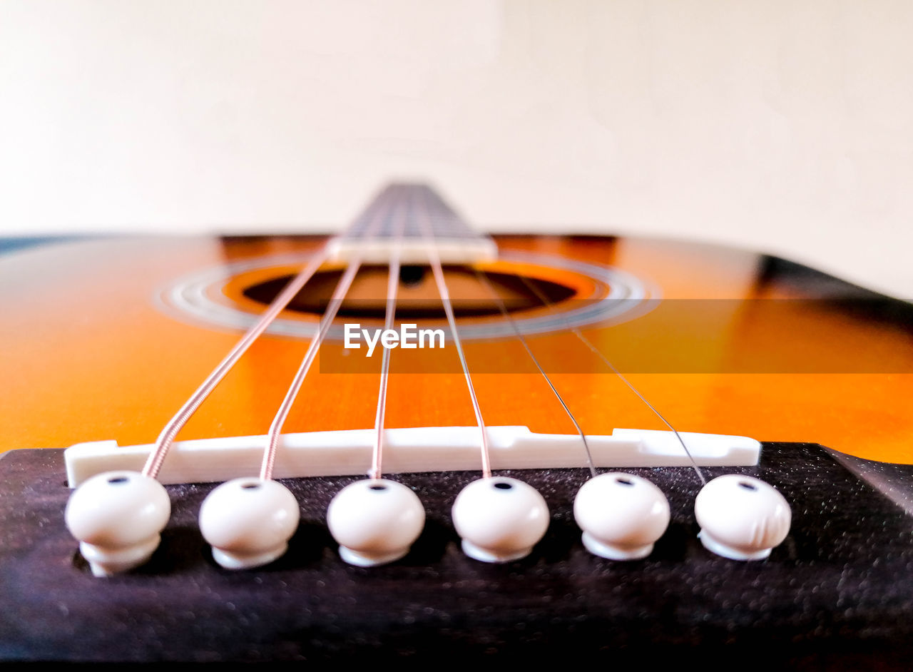 CLOSE-UP OF GUITAR AND TABLE
