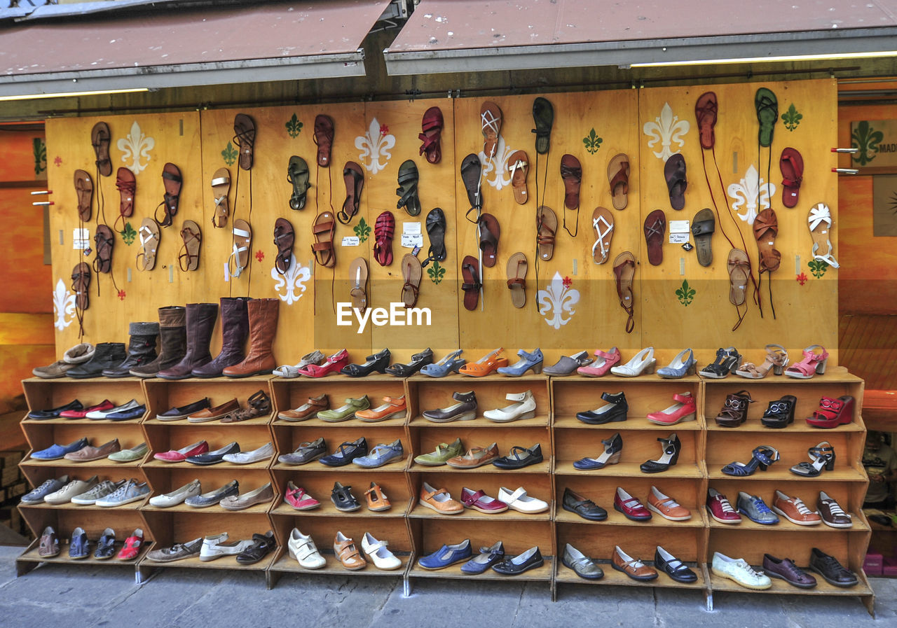 ROW OF CLOTHES HANGING ON WOODEN POST