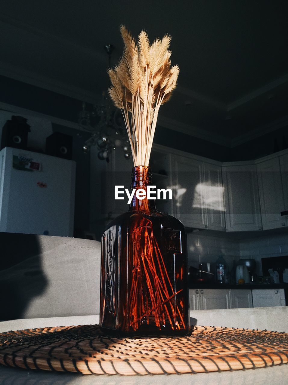 Dry spikelets in a bottle on a table in a sunbeam