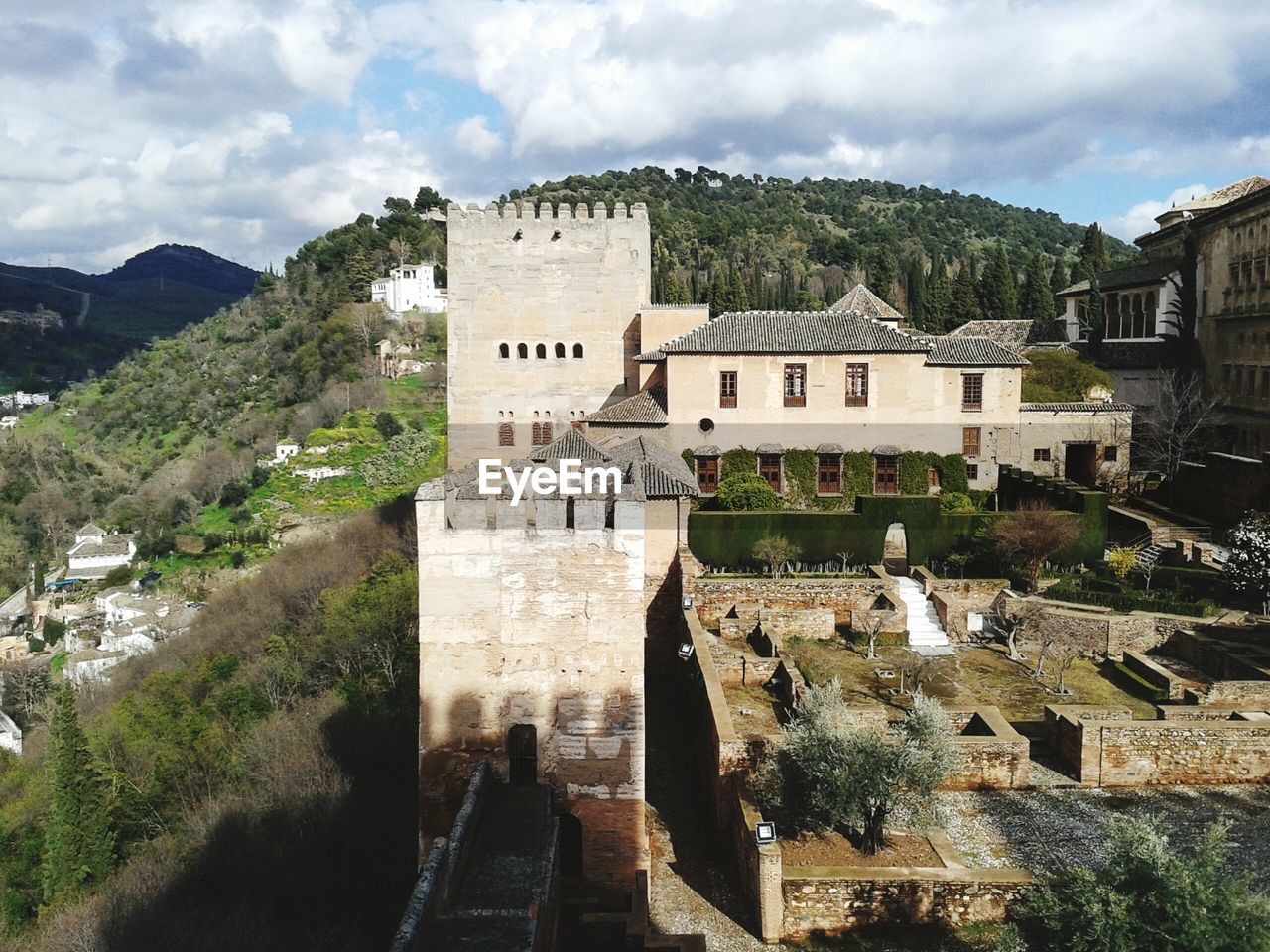 EXTERIOR OF CASTLE AGAINST CLOUDY SKY