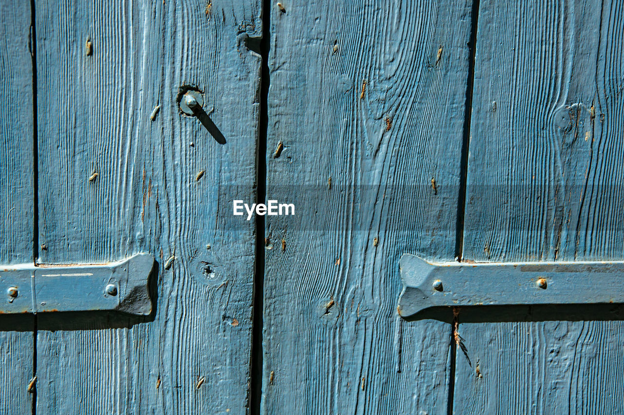 FULL FRAME SHOT OF CLOSED DOOR WITH METAL GATE