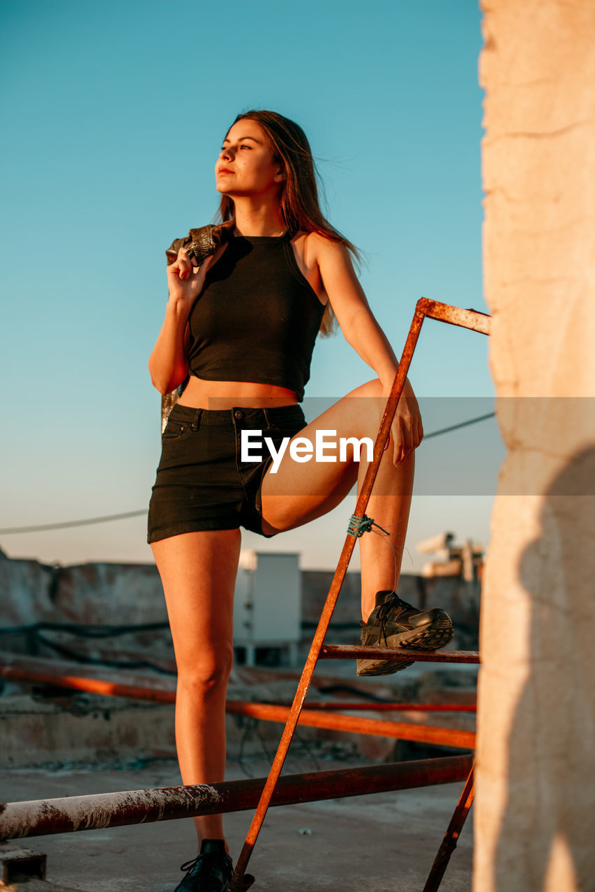 Young woman on terrace during sunset