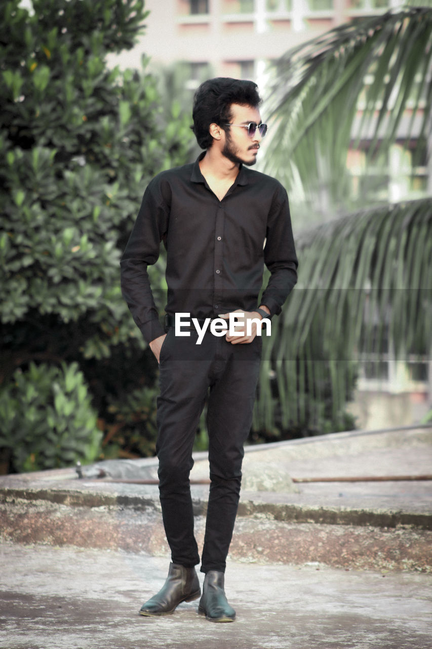 Portrait of young man standing on street