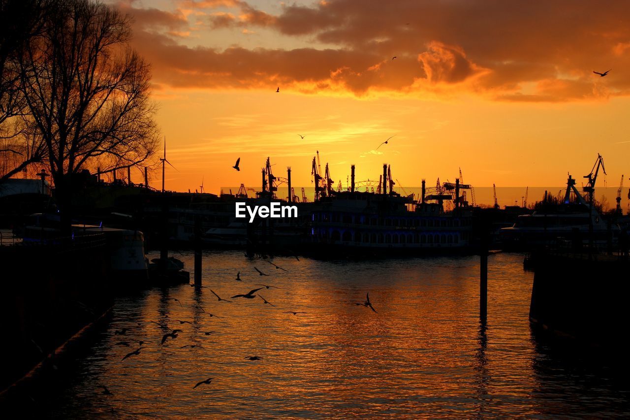 BOATS MOORED AT HARBOR