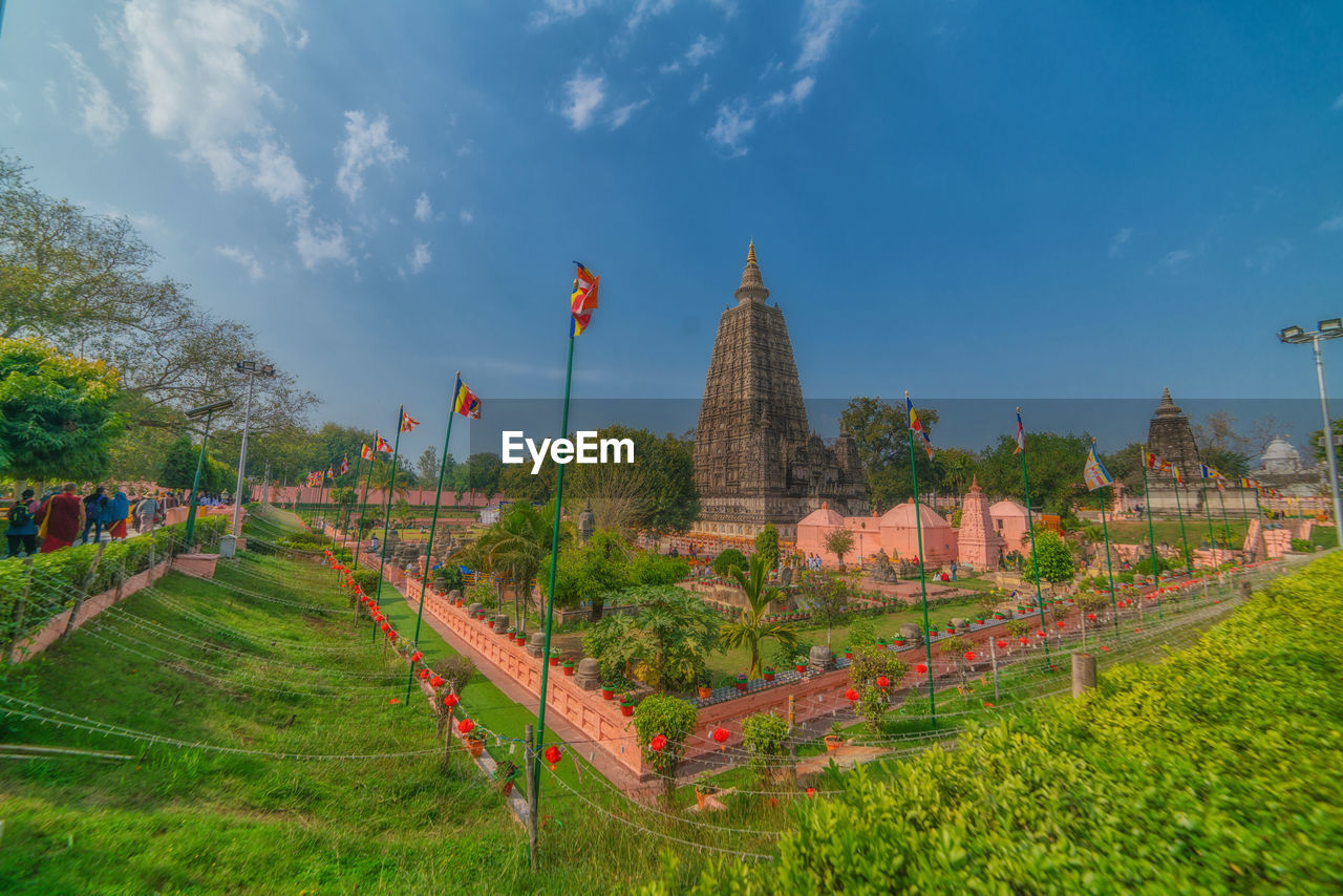 Panoramic view of temple and buildings against sky