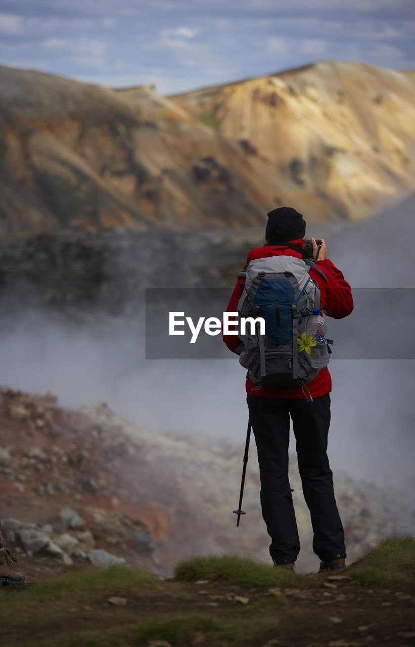 Woman stopping to admire the view on laugavegur hiking trail