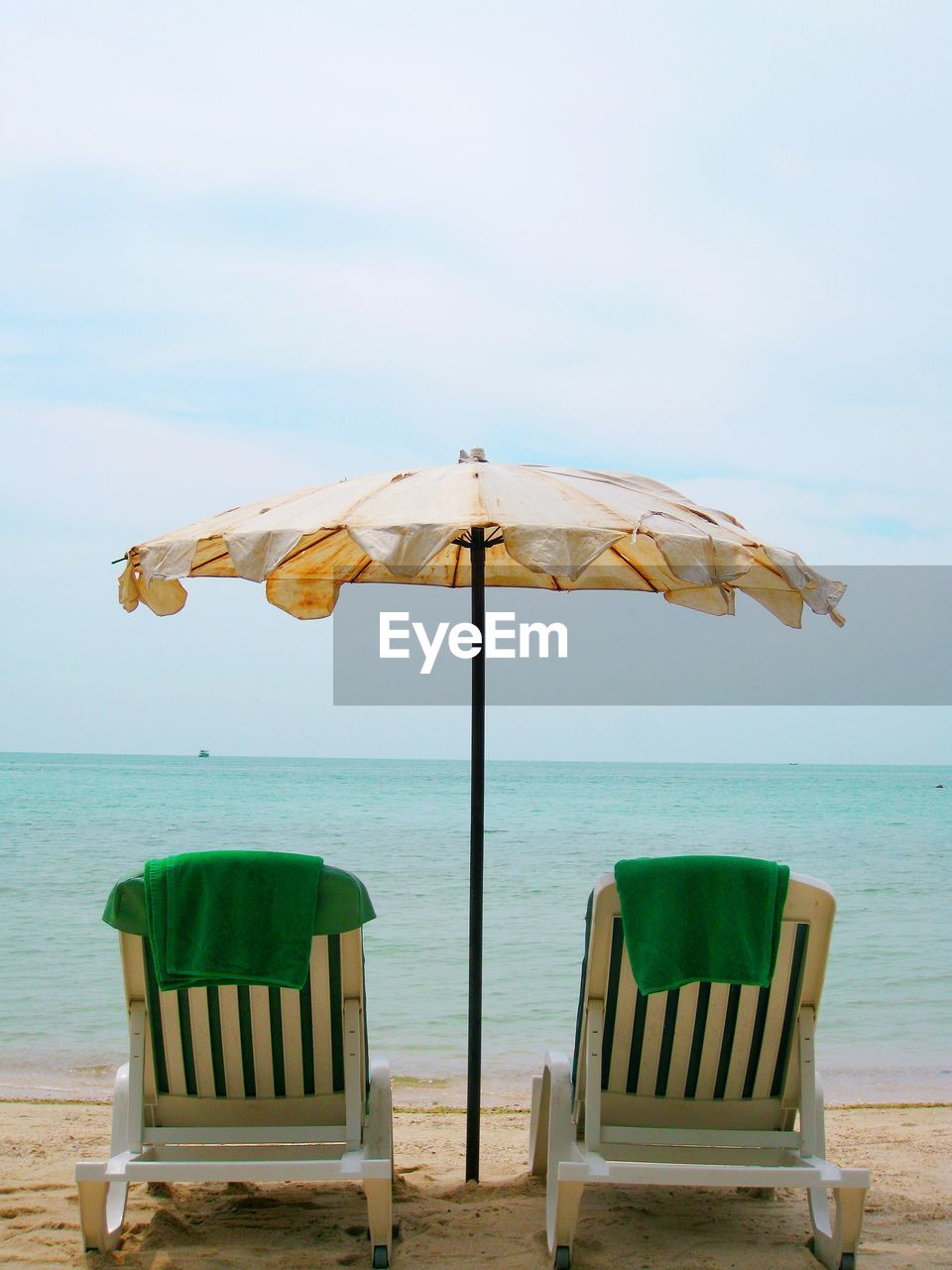 CHAIR ON BEACH AGAINST SKY