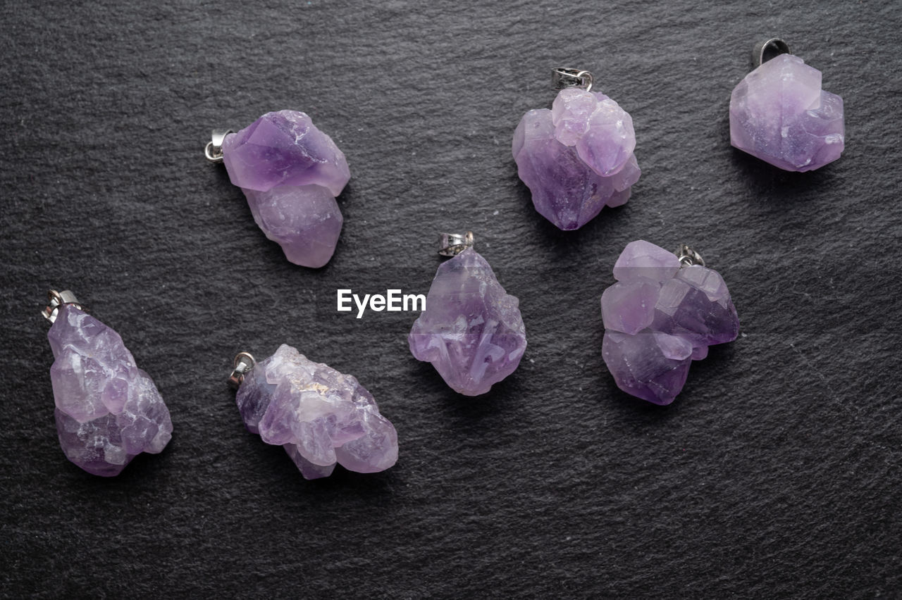 High angle view of purple gems on table