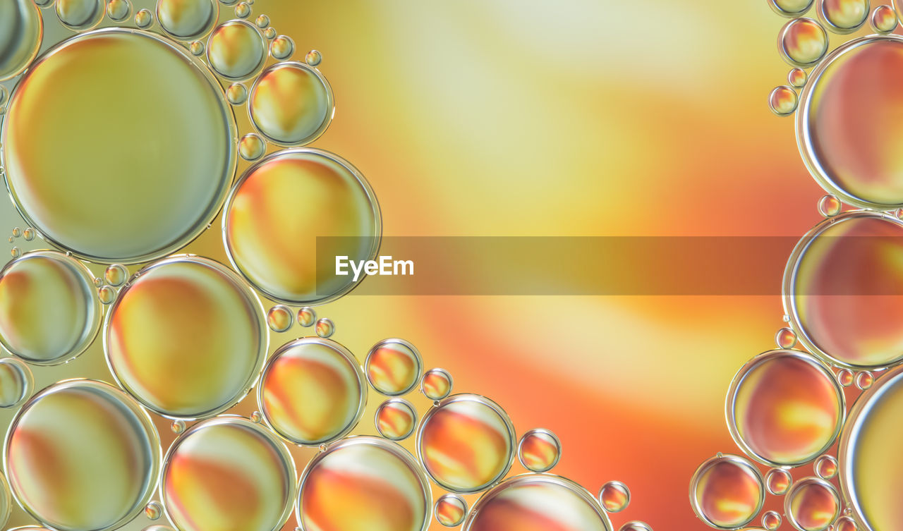 Close-up of bubbles in orange liquid