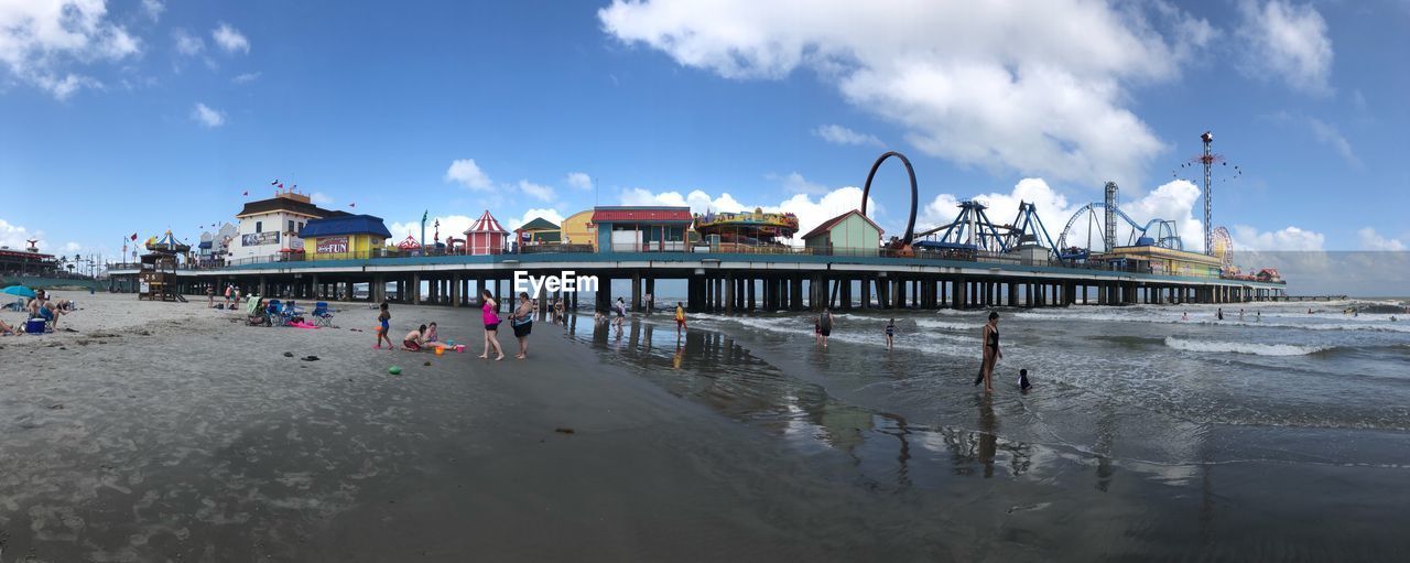 PANORAMIC VIEW OF PEOPLE ON BEACH