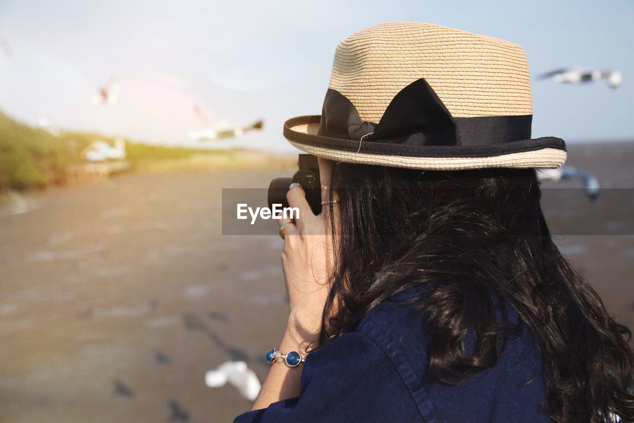 Woman wearing hat against sky