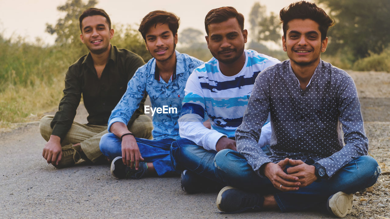 Portrait of people sitting on land