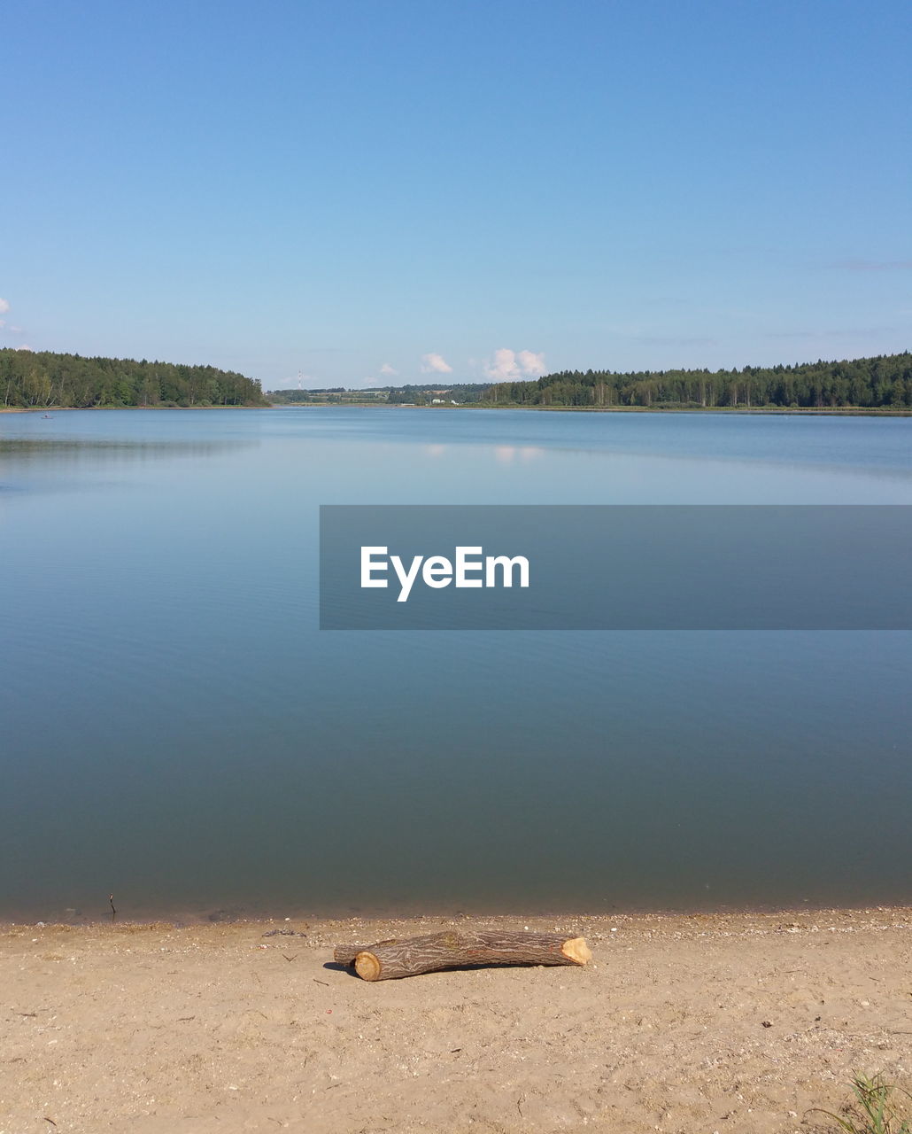 Scenic view of lake against clear blue sky