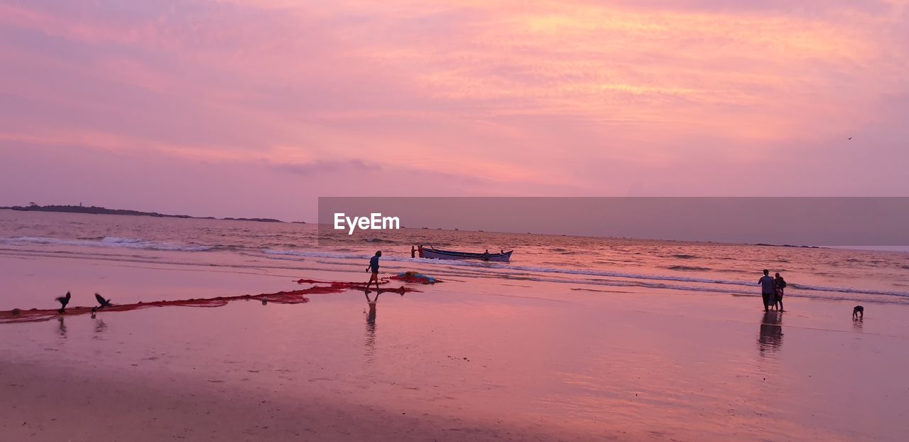 SCENIC VIEW OF BEACH DURING SUNSET