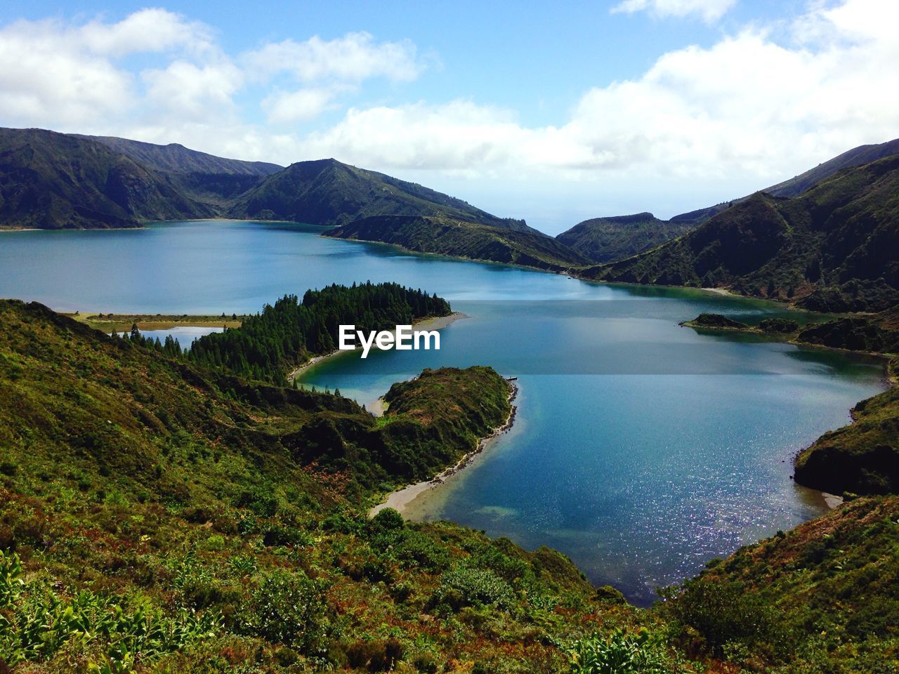 Scenic view of lake against cloudy sky