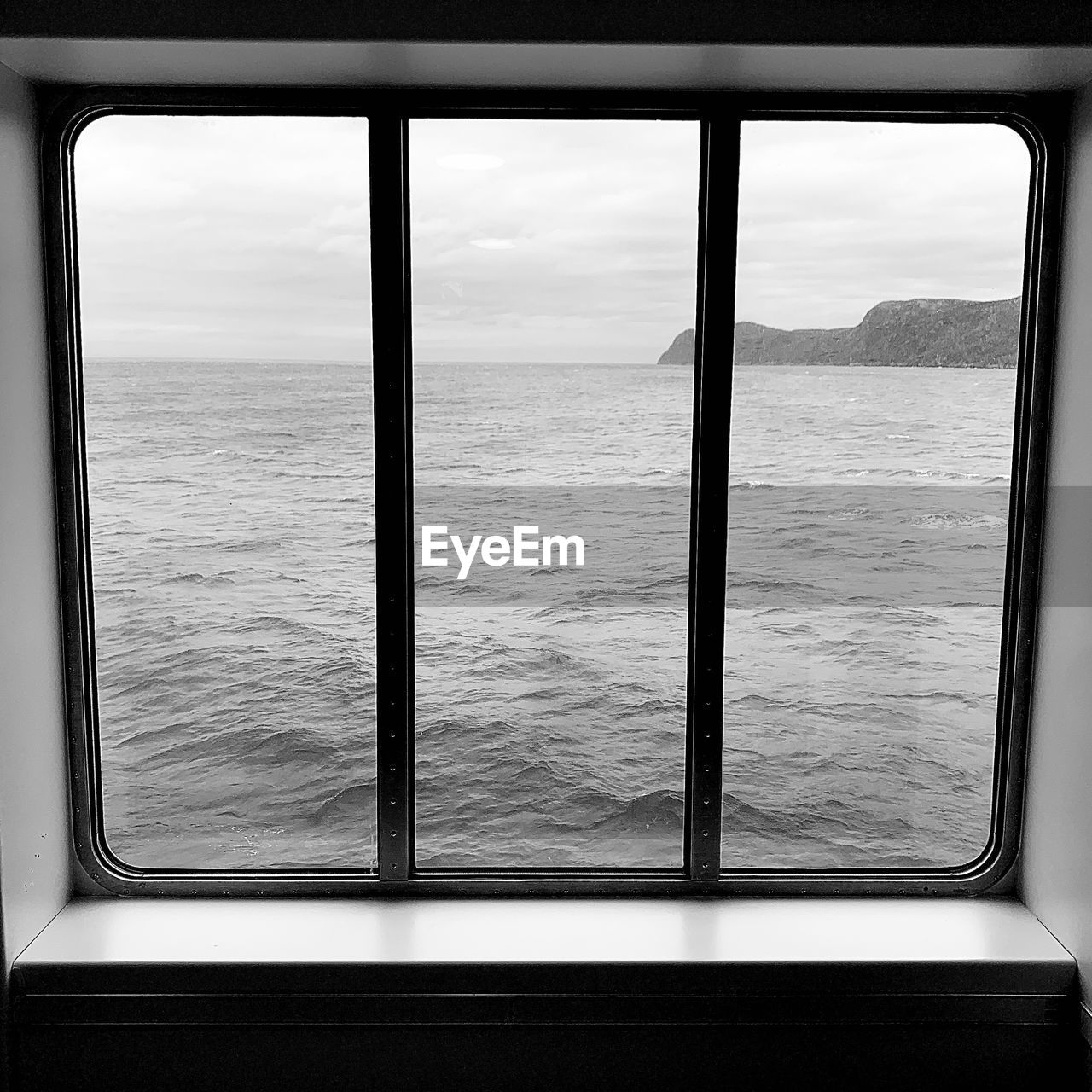 window, black, sea, water, sky, black and white, white, nature, transportation, no people, mode of transportation, travel, scenics - nature, monochrome photography, day, light, glass, cloud, monochrome, transparent, horizon, outdoors, architecture, beauty in nature, horizon over water, interior design, tranquility, vehicle interior, land, looking through window