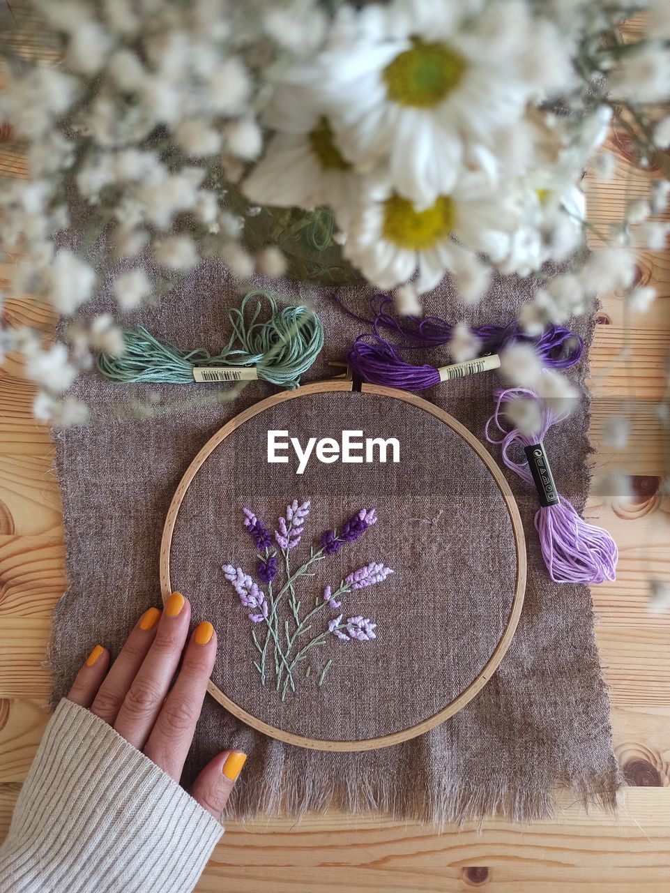 cropped hand of person holding flowers