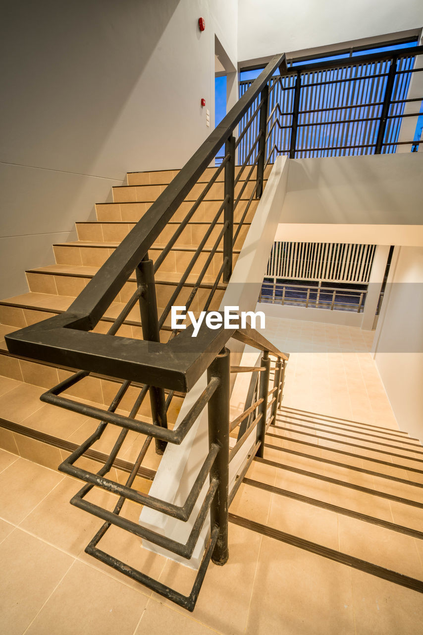 LOW ANGLE VIEW OF STAIRS IN CORRIDOR