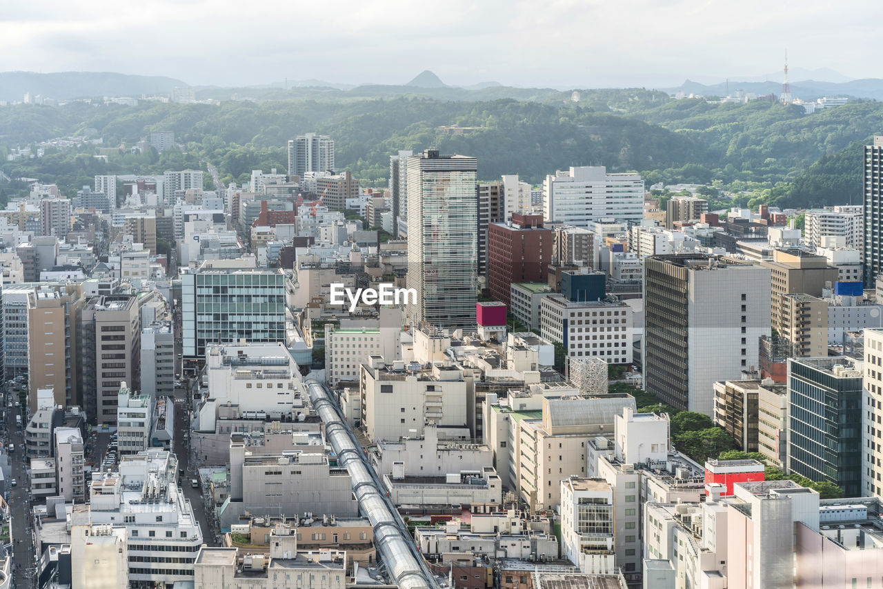 HIGH ANGLE VIEW OF CITY BUILDINGS AGAINST SKY