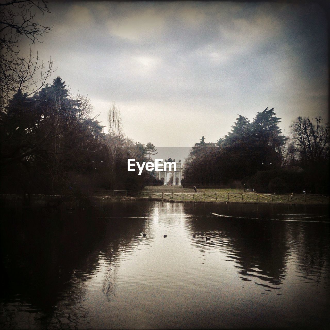 Scenic view of lake against cloudy sly