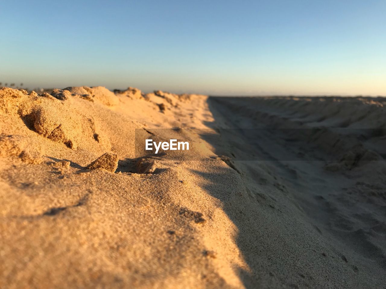 Close-up of sand dunes against clear sky