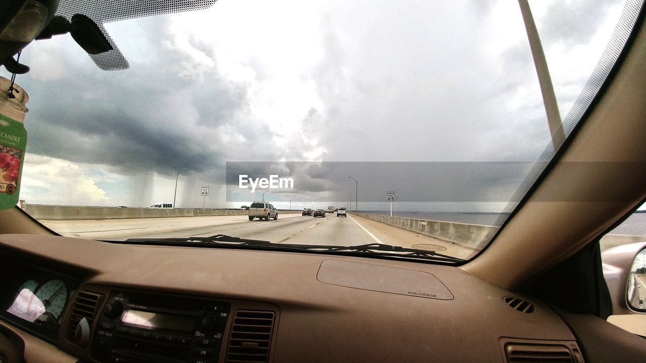 LOW ANGLE VIEW OF AIRPLANE WING OVER ROAD